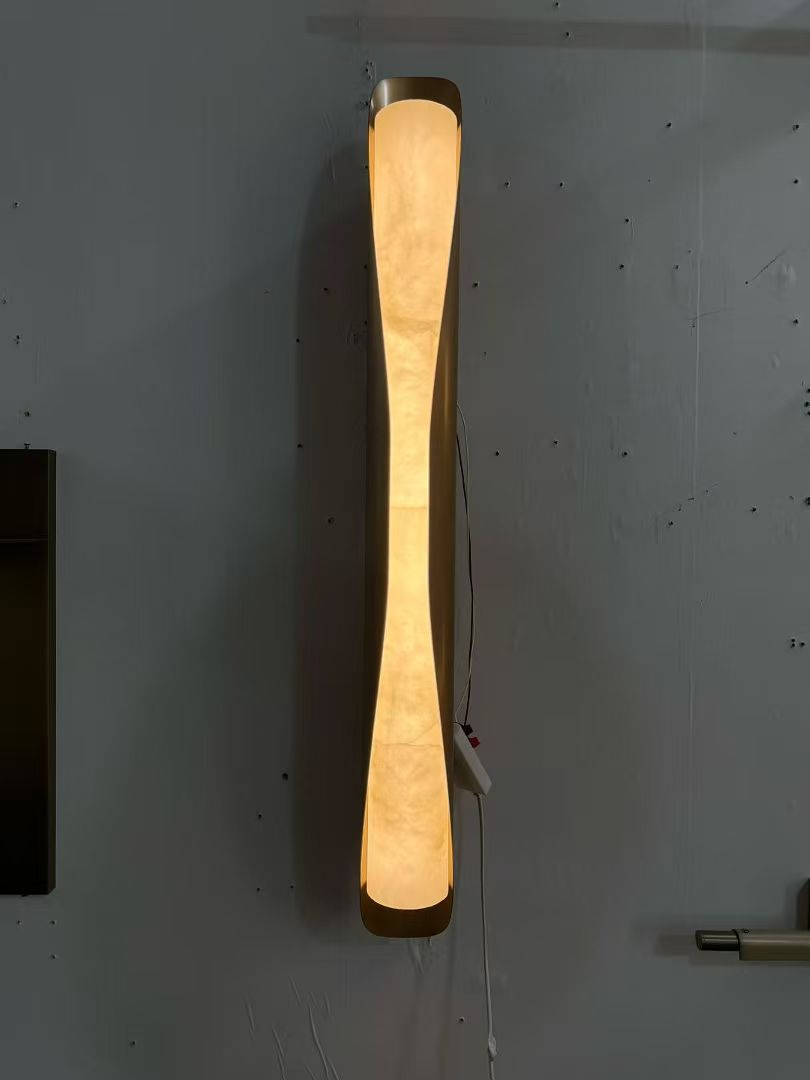 Tapered illuminated wall light photographed in the workshop