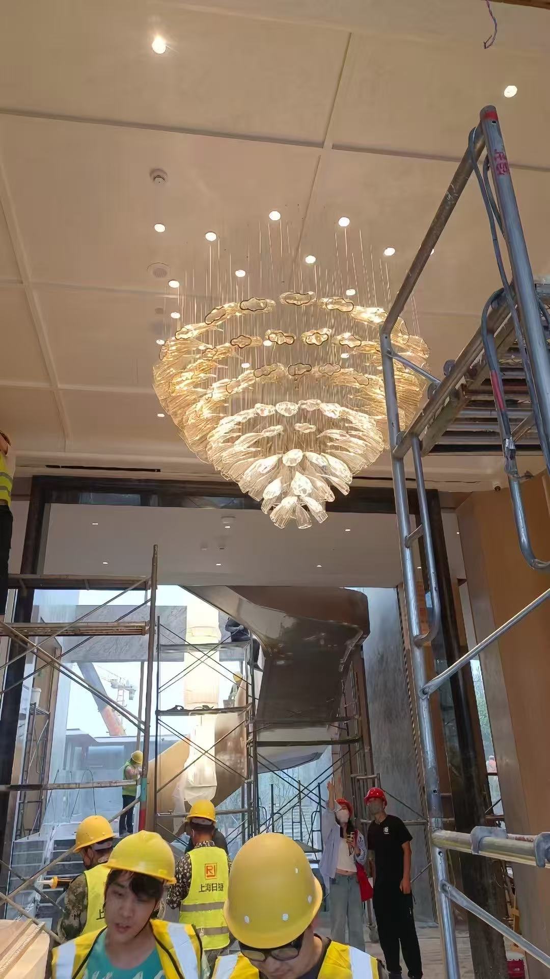 Large glass chandelier during on-site installation