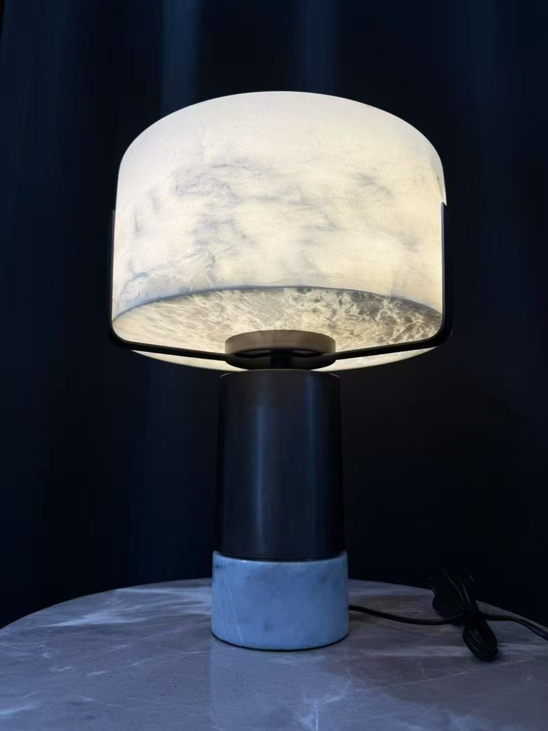 Illuminated alabaster-style table lamp during testing