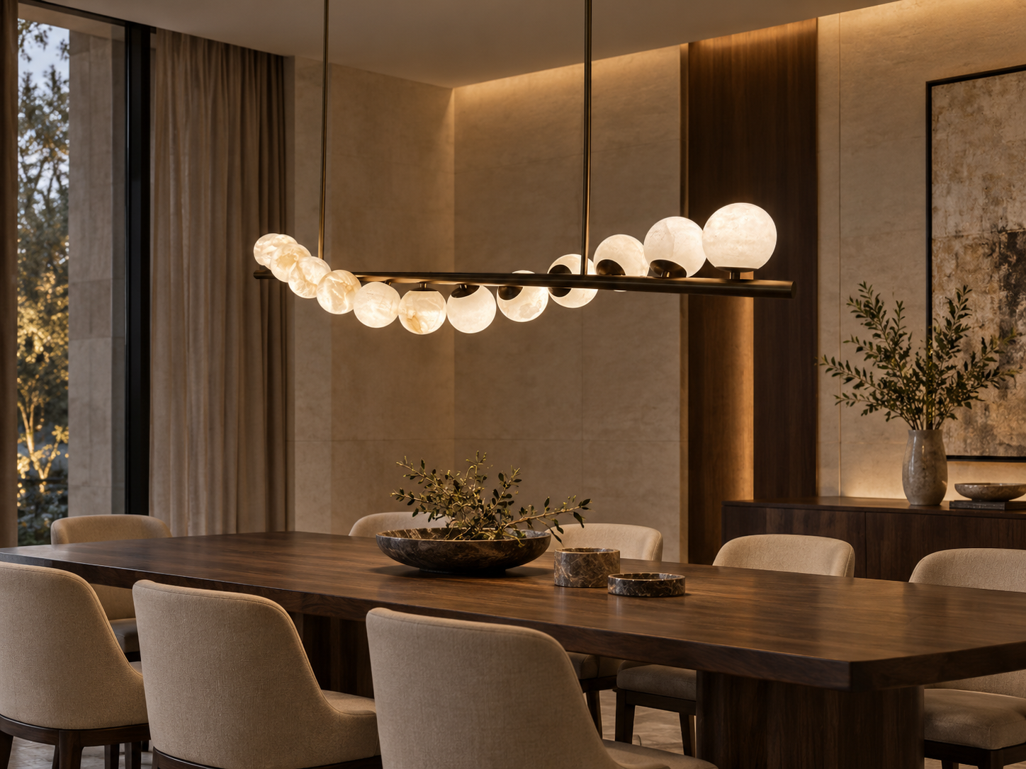 Glowing stone spheres on a linear pendant above a dining table