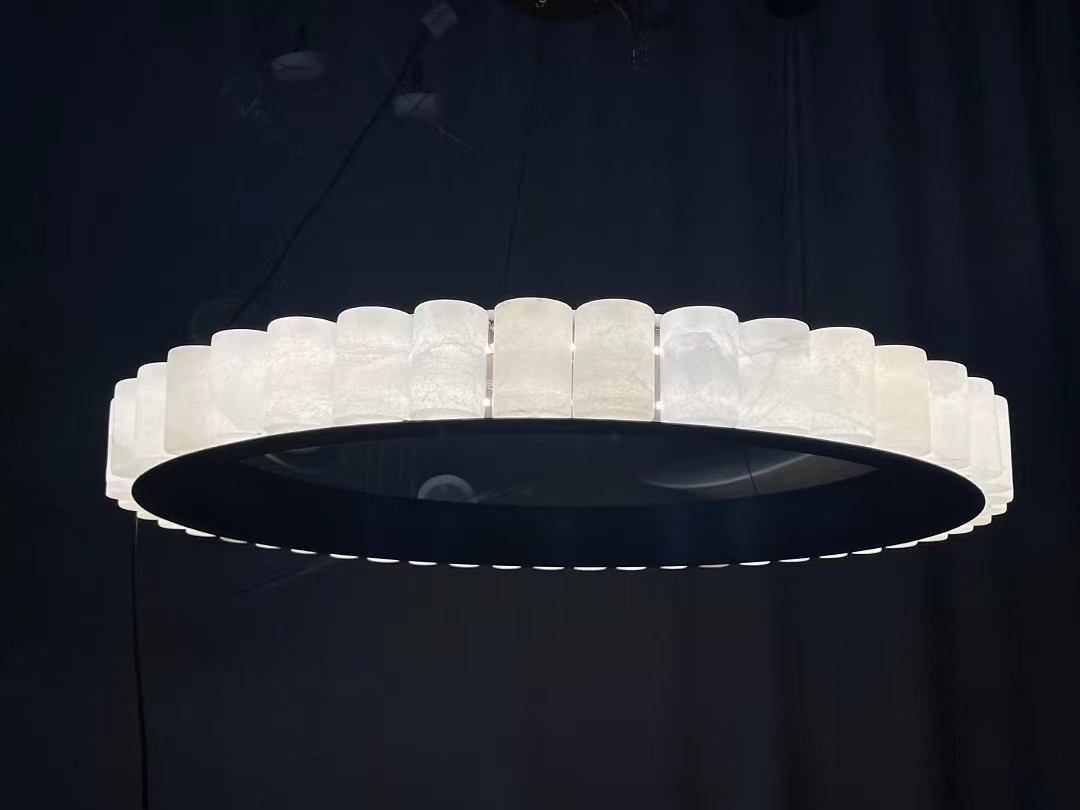 Circular chandelier with illuminated stone shades in the workshop