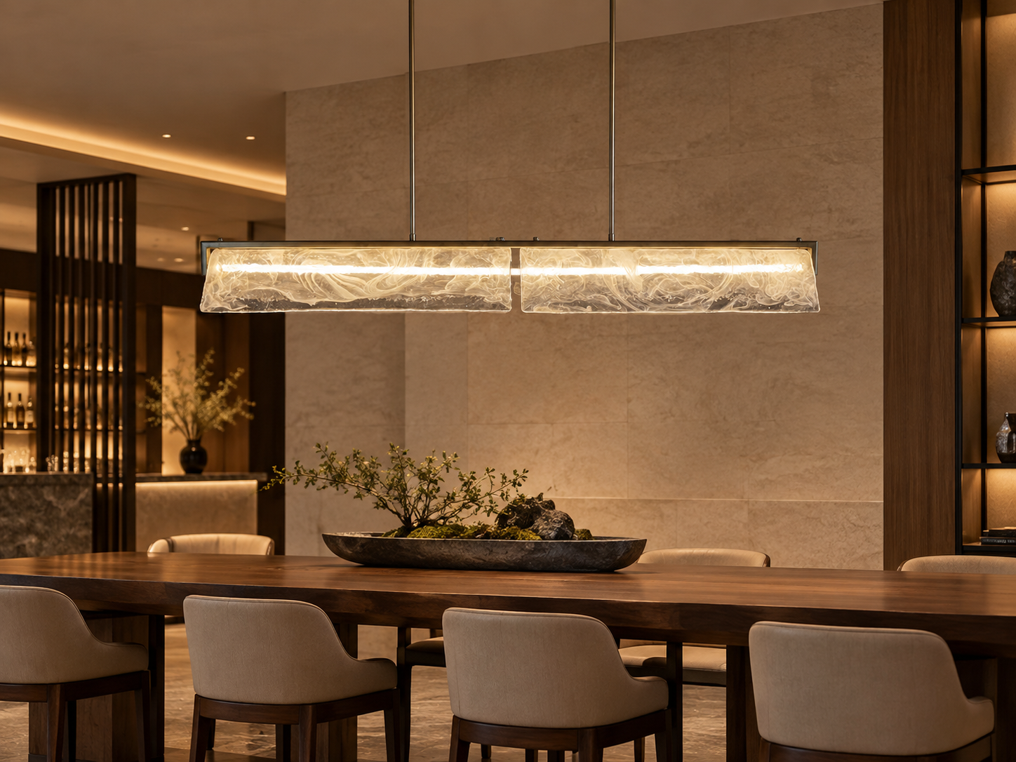 Textured glass linear pendant above a long dining table