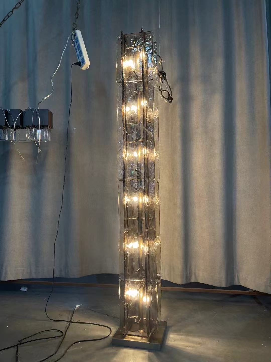Stacked transparent glass floor lamp during workshop testing