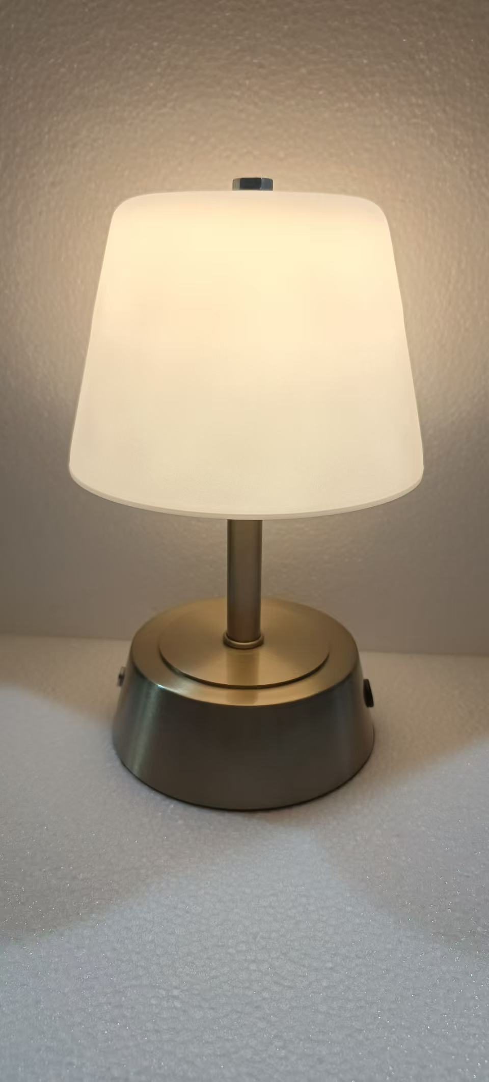 Shaded brass table lamp photographed in the workshop