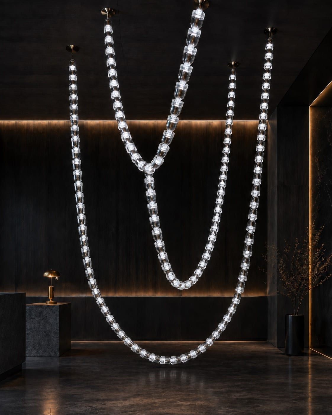 Long illuminated transparent chains suspended in sweeping curves within a dark hospitality interior.