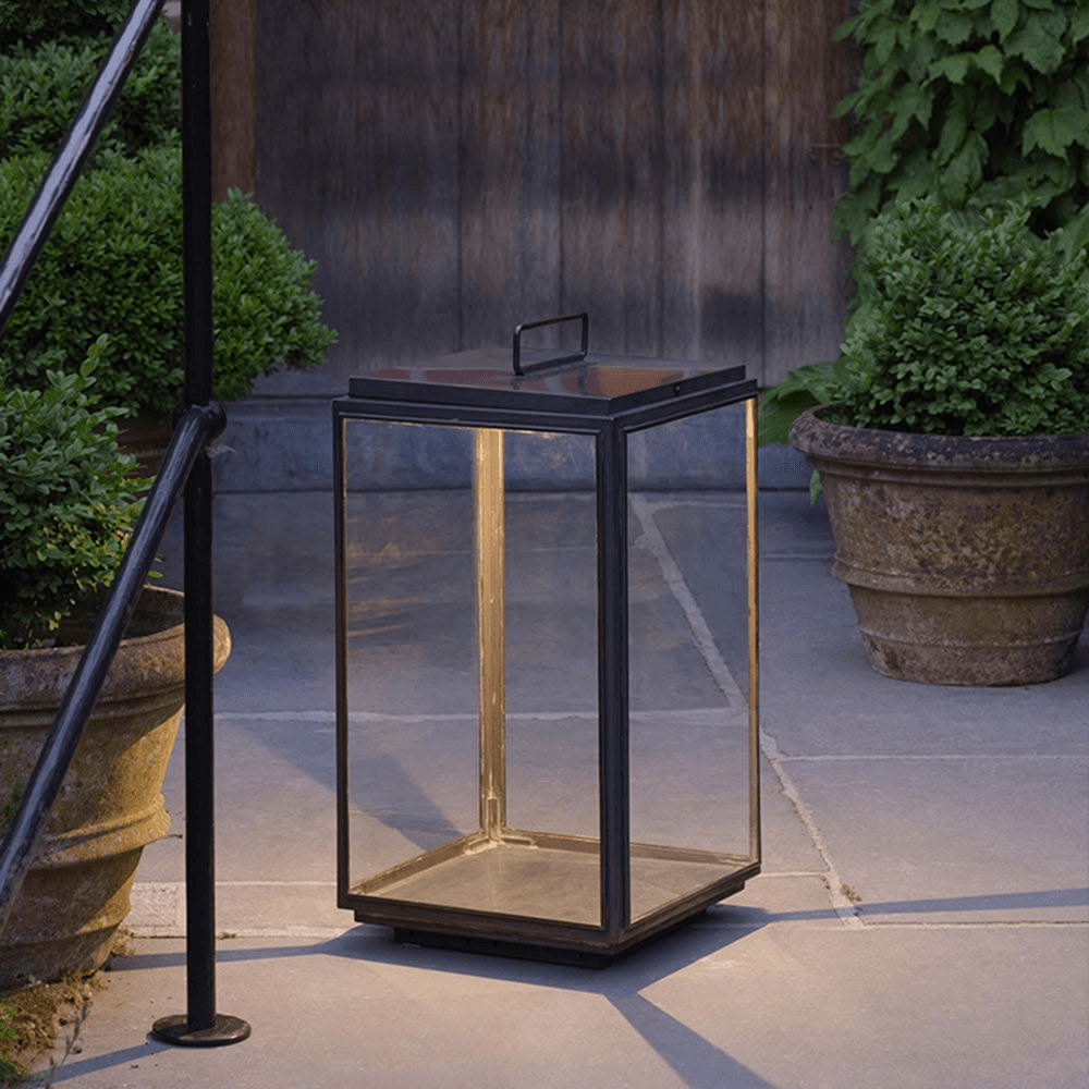 Custom black framed glass outdoor lantern positioned at a heritage hotel entrance.