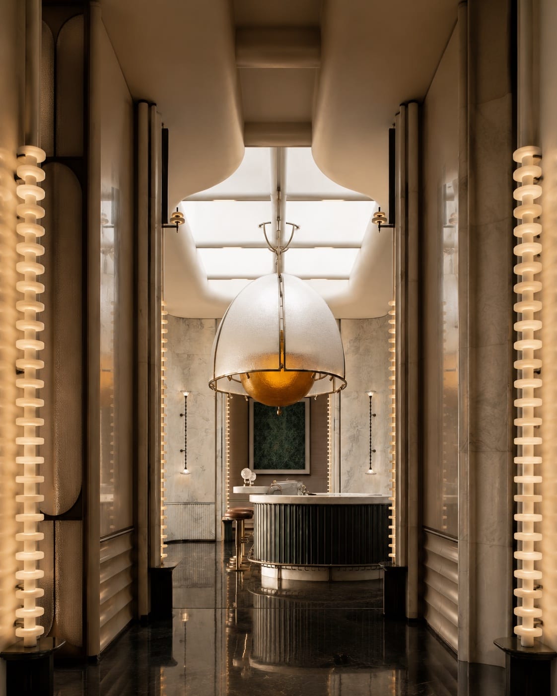 Sculptural dome pendant framed by vertical architectural lighting