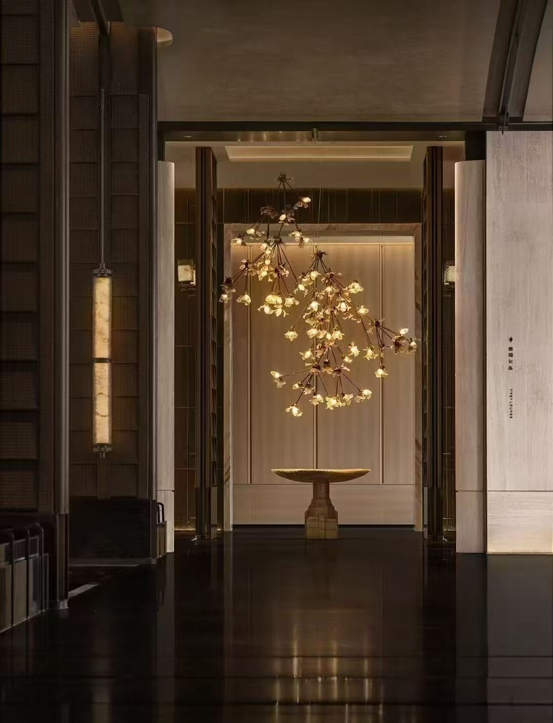 Sculptural chandelier forming a focal point in a dramatic entrance