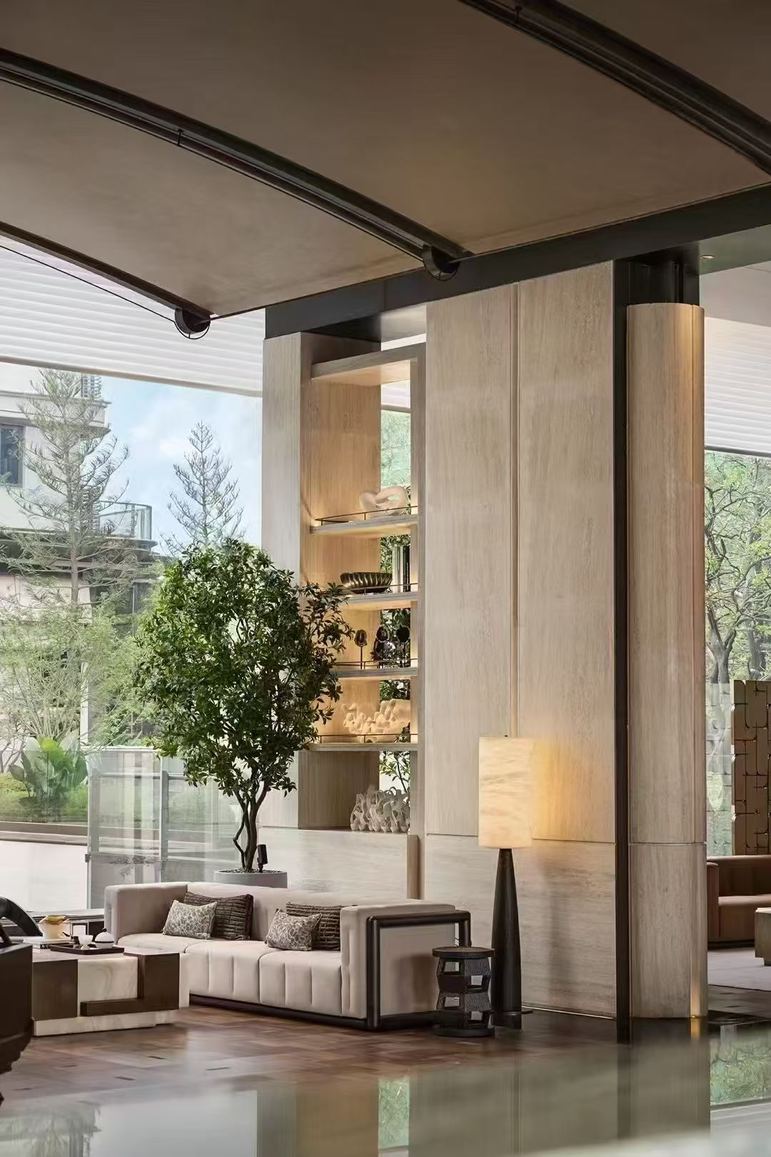 Softly illuminated floor lamp beside lounge seating and large windows