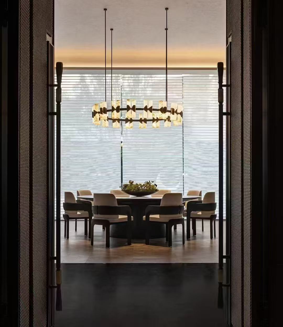Suspended chandelier above a round dining table