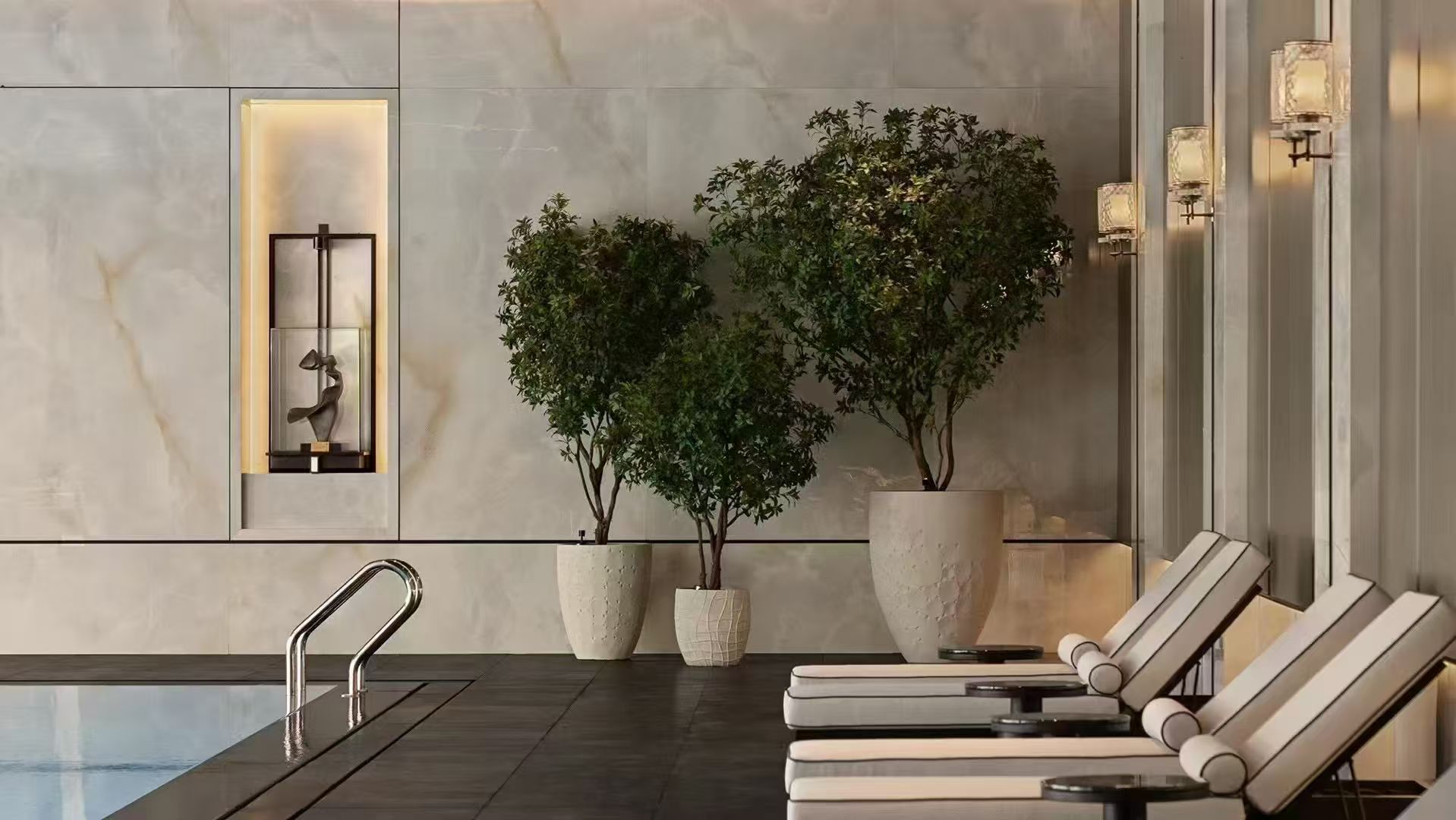 Wall lights above poolside loungers in a calm leisure interior