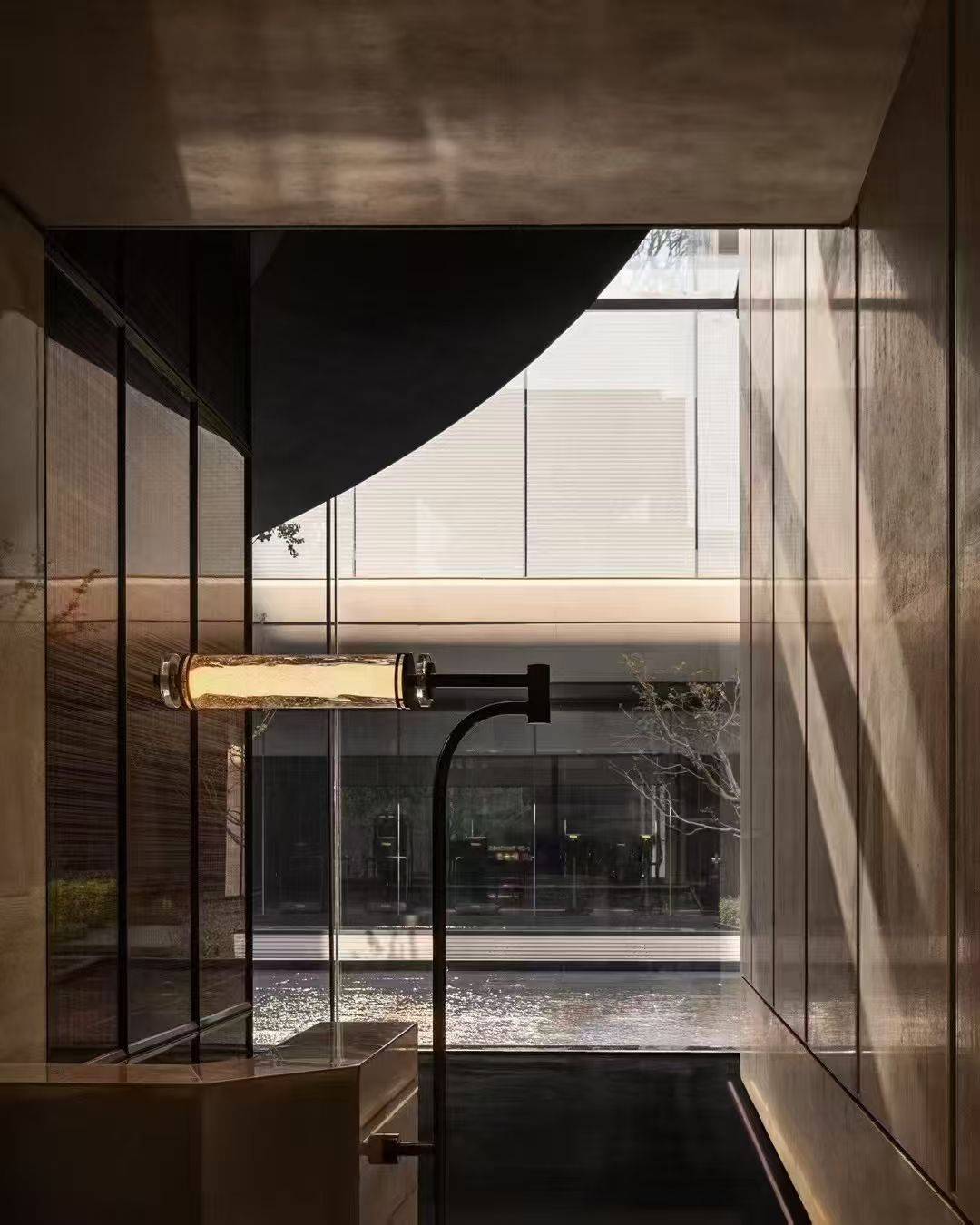 Horizontal cylindrical light beside a passage overlooking water