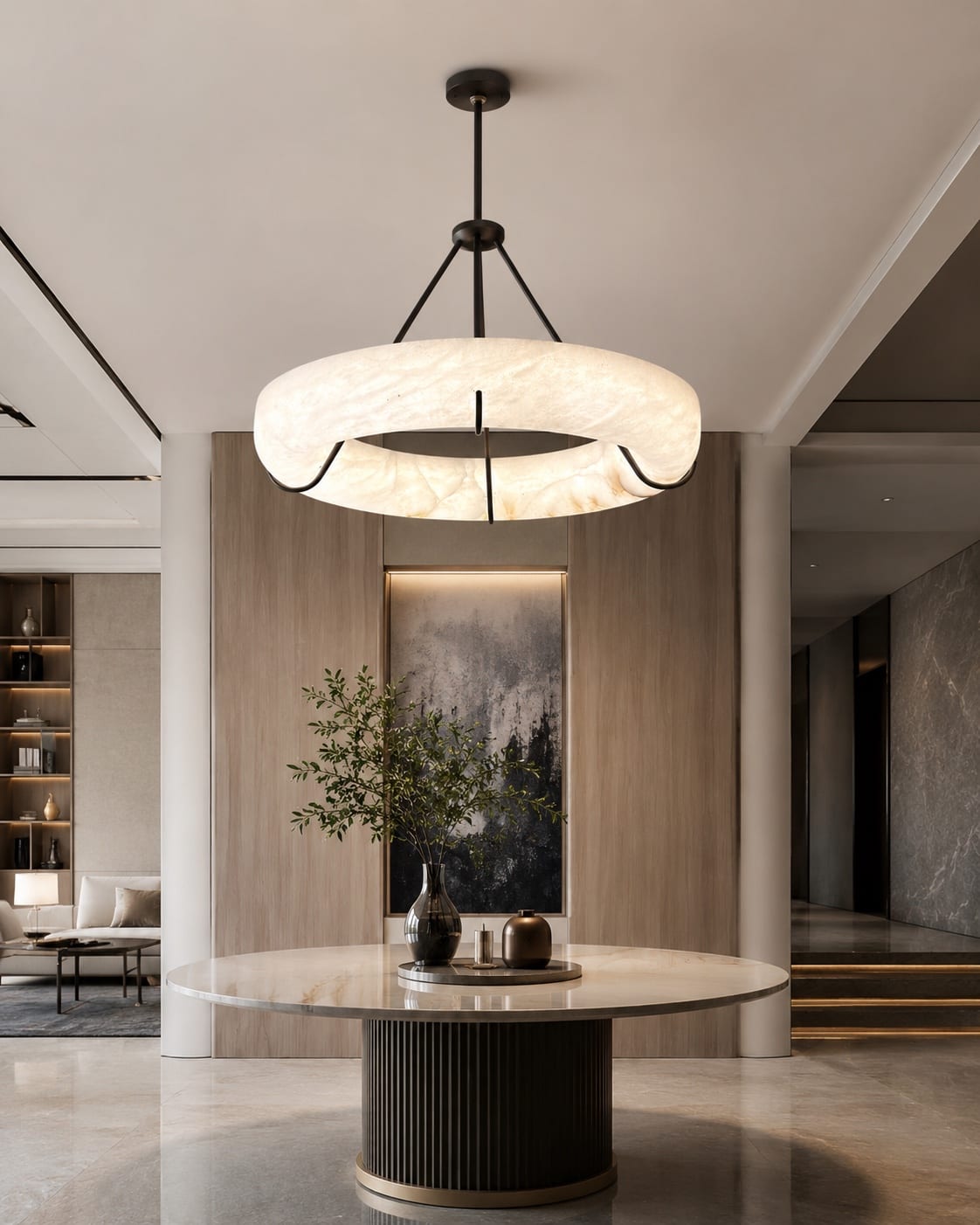 Large illuminated alabaster ring pendant suspended above a round table in a refined interior