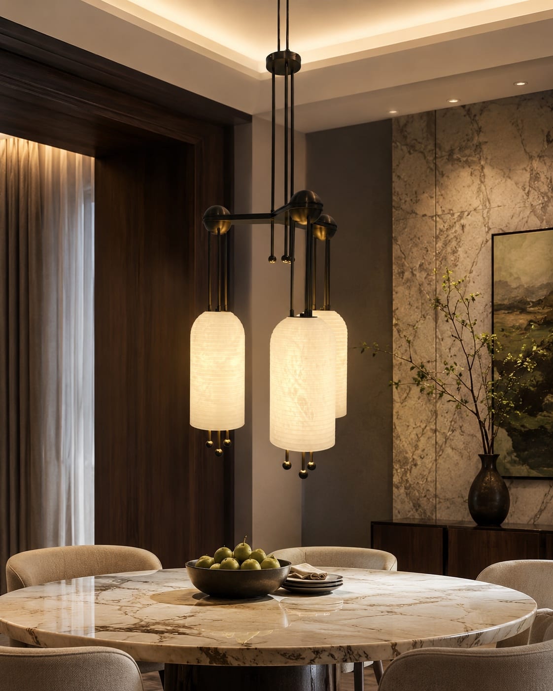 Cluster of three ribbed alabaster pendants with dark metal fittings above a dining table