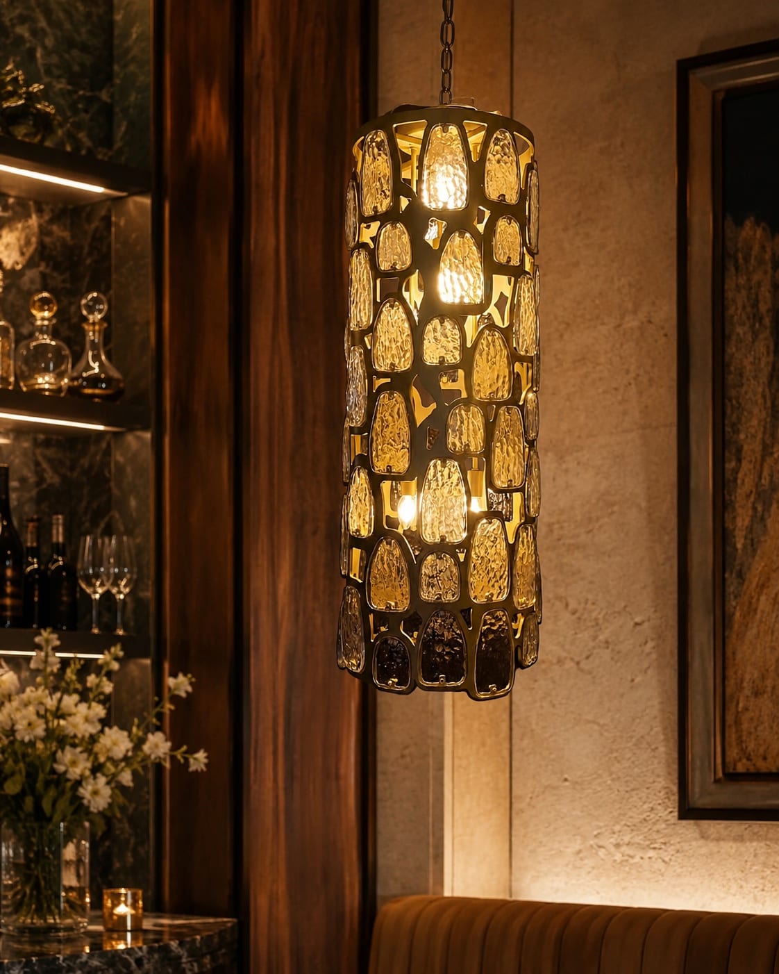 Tall cylindrical lantern pendant with textured amber glass panels and dark metal framework
