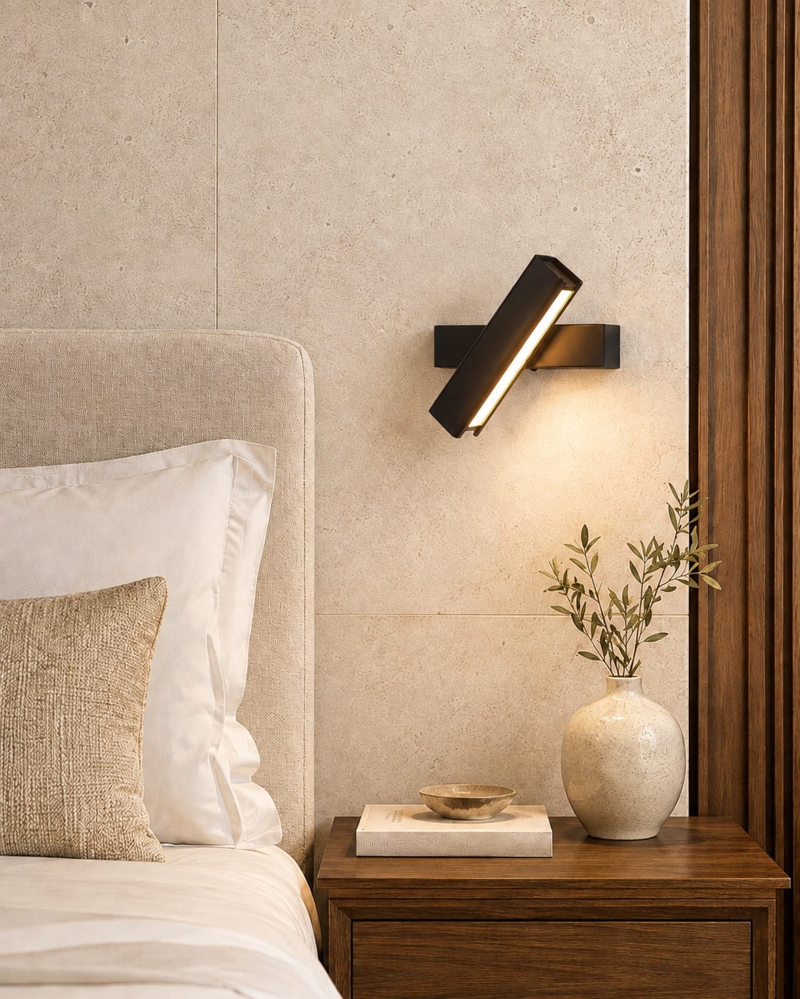 Slim adjustable black linear bedside reading light above a timber nightstand in a contemporary hotel room