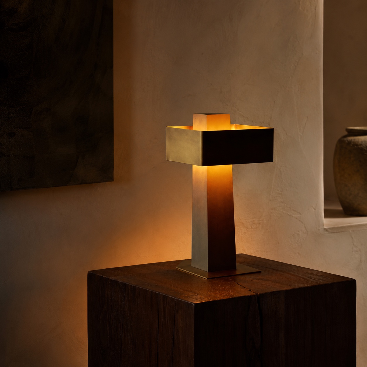 Custom geometric table lamp with intersecting dark metal and warm illuminated forms