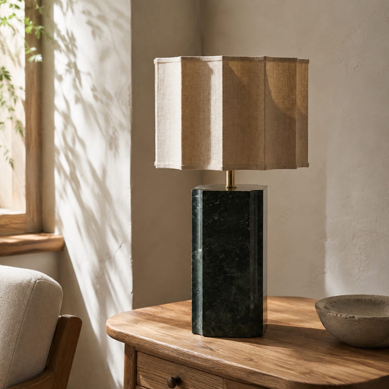Custom table lamp with a polished green stone block base and pleated natural linen shade