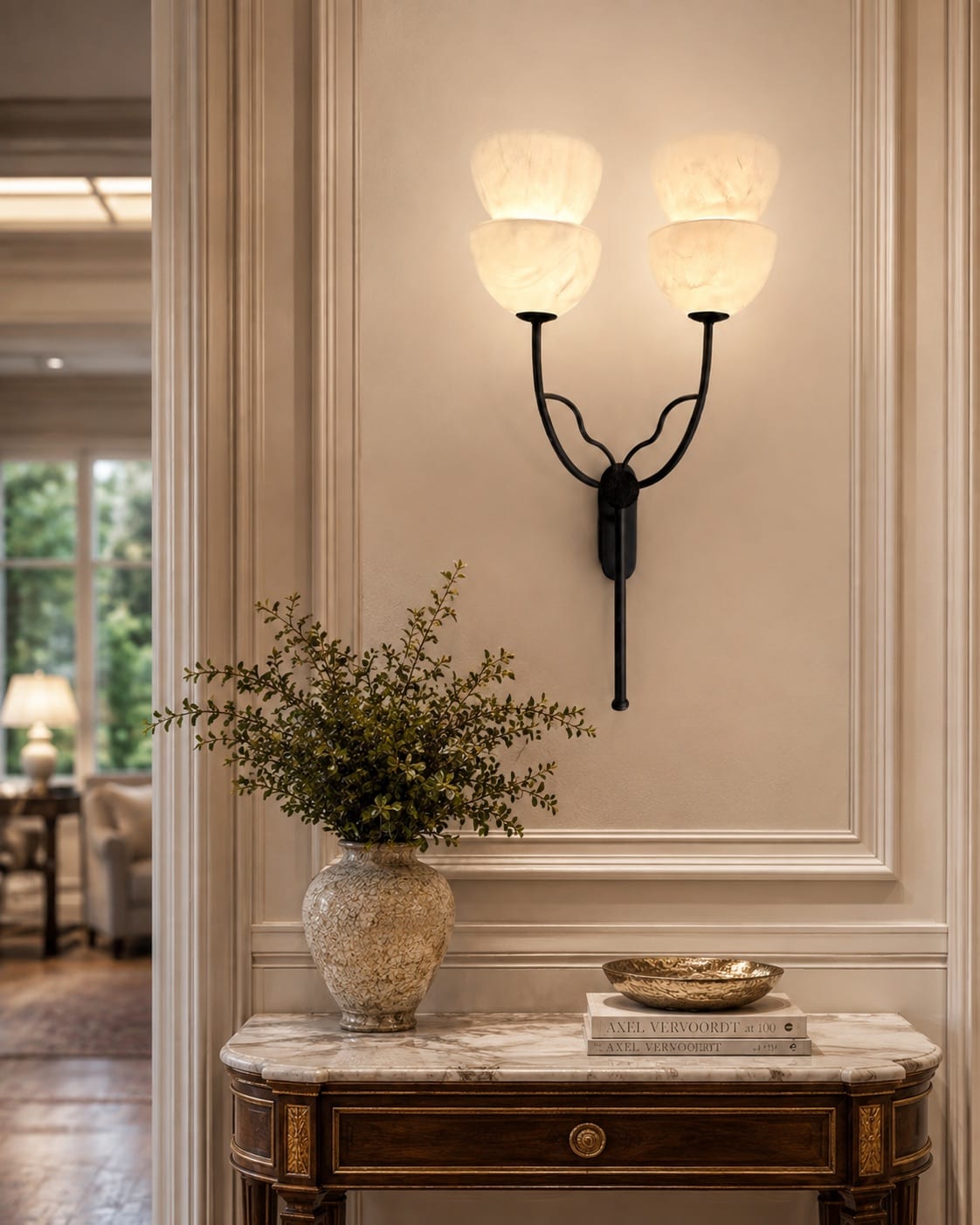Custom twin-arm wall light with four softly illuminated marbled glass shades in a classic interior